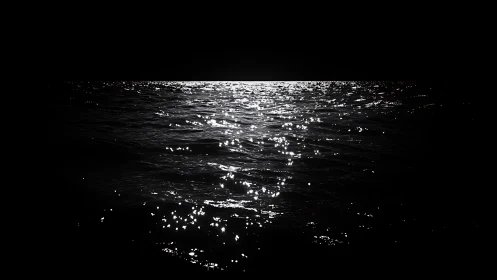 Luminous horizon over dark ocean with high-contrast waves.
