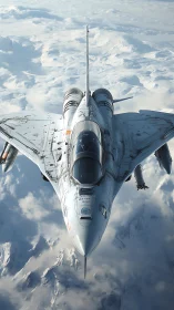Futuristic white fighter jet cruises above frozen mountains.