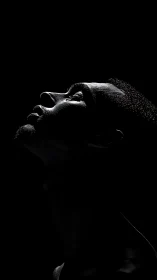 Profile portrait in dramatic low key side lighting.