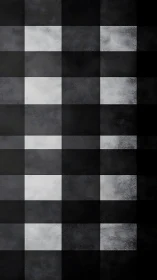 Monochrome textured grid pattern with square tile layout.