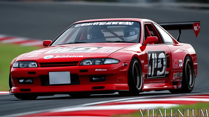 Red race-prepared coupe negotiates corner on track surface