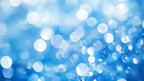 Iridescent water bokeh with luminous blue highlights.