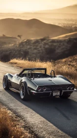 Sunset prowl of a black classic Corvette along golden hills.