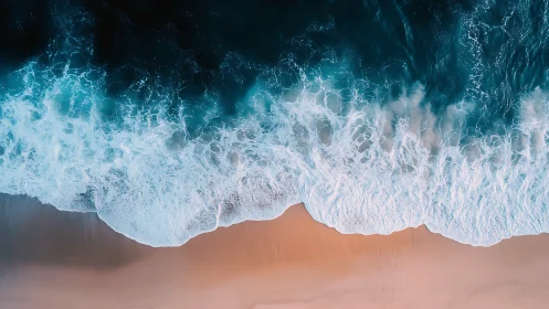 Rolling teal surf washes over soft peach shoreline in calm