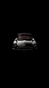 Classic black sports car glows dramatically against darkness