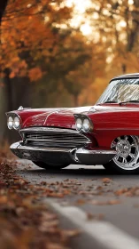 Restored red 1950s coupe front end under soft autumn bokeh
