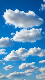 Layered cumulus clouds across uniform blue daytime sky.