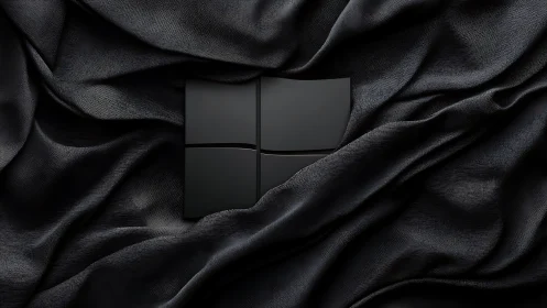 Velvet shadows cradle a sleek black windowed emblem.