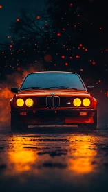 Vintage red sports coupe is shown frontally in low light