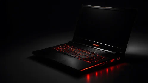 Midnight gaming laptop glows with molten red circuitry light.