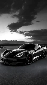 Black supercar cuts through moody mountain highway dusk.