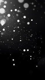 Monochrome light particles on soft blurred black field.