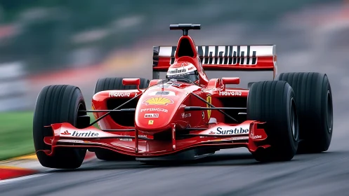 Red Formula race car slices through wet circuit at speed.