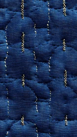 Cozy indigo quilt texture with soft stitches and depth.