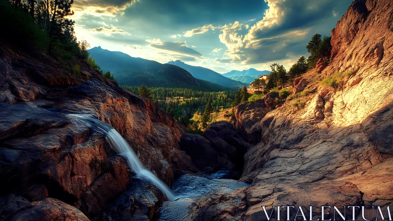 Mountain gorge waterfall under dramatic sunset skies.