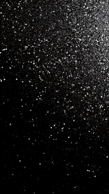 Silver specks drifting through a quiet midnight sky.