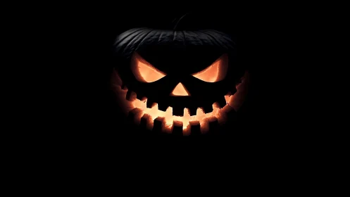 Glowing jack o’lantern smiles sharply from the Halloween dark