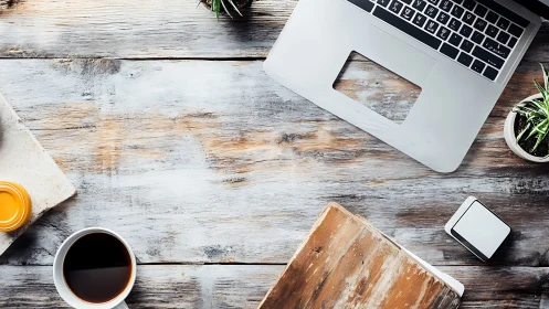 Laptop workstation with distressed wood surface topology.
