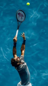 Overhead tennis serve capture isolates athlete against cyan court