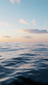 Soft evening waves under a wide, pastel painted sky.