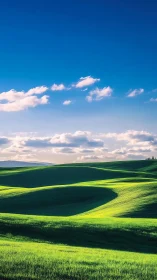 Sunlit green hills rolling beneath vivid blue sky glow.