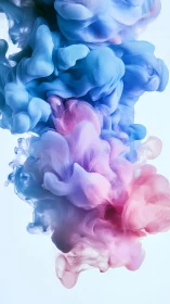 Colored ink clouds suspended in liquid against light backdrop.