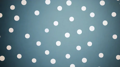White polka dots scatter across muted teal background.