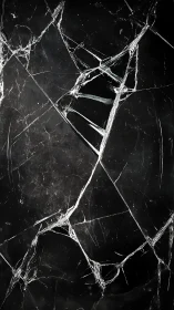 Shattered glass fractures over deep black reflective void.