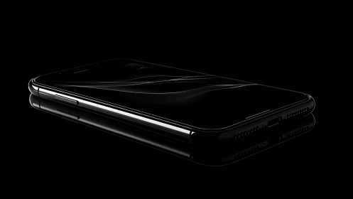 Curved-edge black smartphone in dramatic studio lighting.