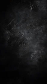 Dark textured grunge surface presents subtle smoky gradients
