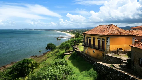 Coastal hillside village with tiled roofs and calm shoreline.