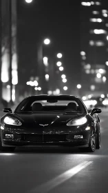 Black sports car glides through luminous night city street