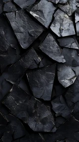 Stacked irregular dark slate fragments in close view.