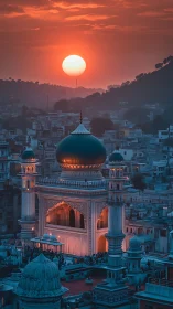 Sunset over illuminated Indo-Islamic mosque amid dense hillside city