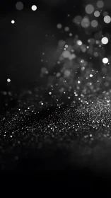 Defocused particulate bokeh field forms layered depth on black