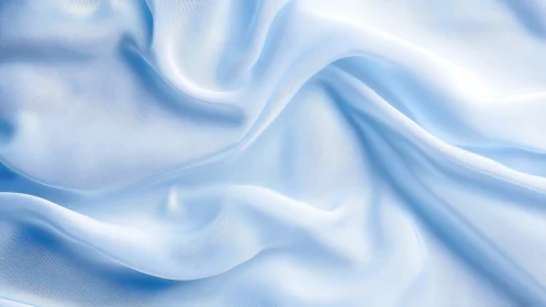Soft blue silk drapery with flowing folds and subtle sheen.