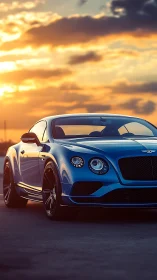 Low-angle study of blue luxury coupe against chromatic sunset sky