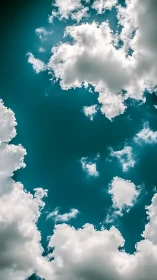 Cumulus cloud ring framing deep teal midday sky center