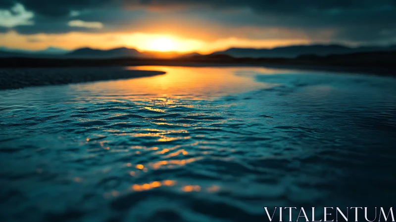 Low-angle view of rippled water under distant sunset horizon.