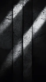 Concrete panels with diagonal light and stark contrast.