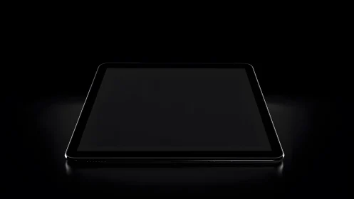 Modern tablet device in dramatic lighting, minimalistic black background.