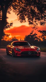 Red Mercedes sports car under vivid sunset sky on road.