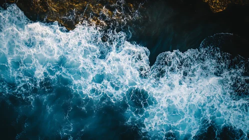 Turbulent ocean surf crashes against rugged coastal rock