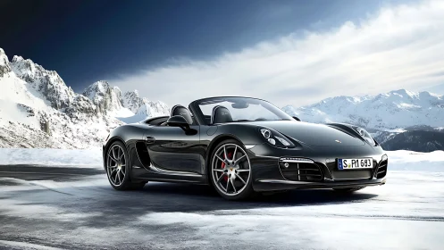 Black convertible sports car on icy alpine plateau under clear sky