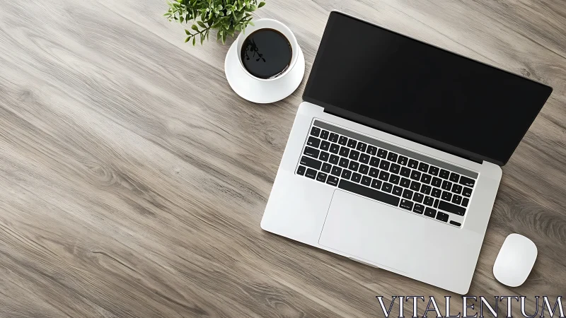 Cozy laptop workspace with coffee on a calm wood desk.