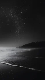 Starry night sky over calm monochrome ocean shoreline.