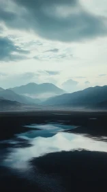 Moody alpine basin renders mirrored sky in cool tonal harmony