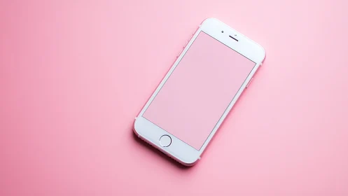 White iPhone on Pink Background Flat Lay.