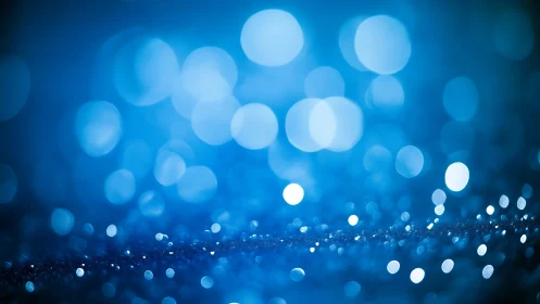 Blue bokeh light circles form defocused abstract background