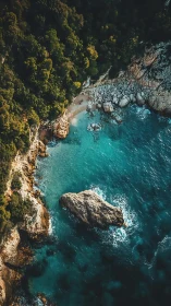 Aerial coastal cove with rocky shoreline and turquoise water.